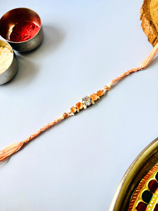 Orange AD Stone Rakhi with Roli Chawal for Brother