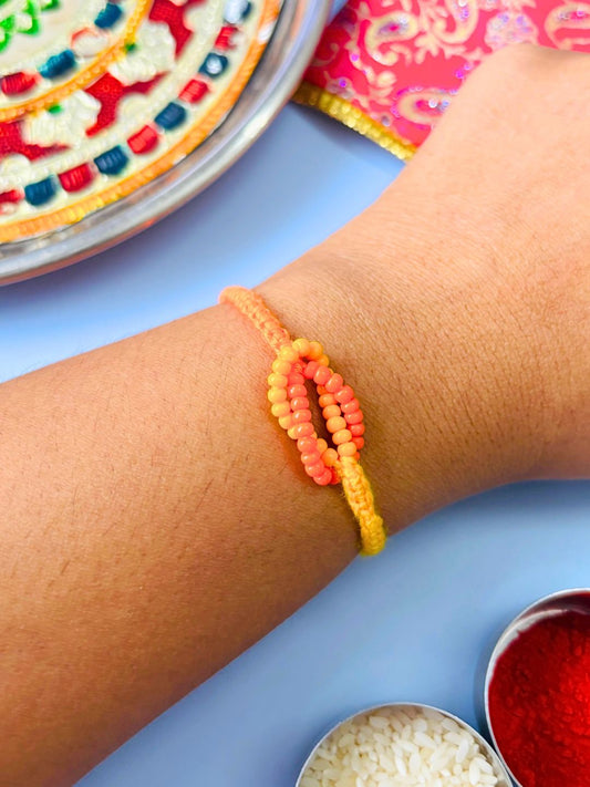 Orange Beaded Thread Rakhi with Roli Chawal