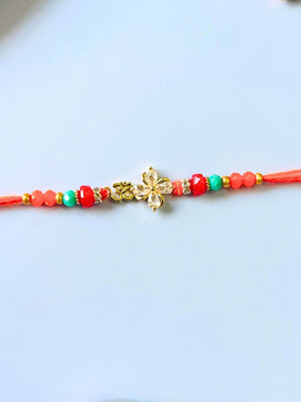 Om AD Stone Rakhi with Floral Accent with Roli Chawal for Brother