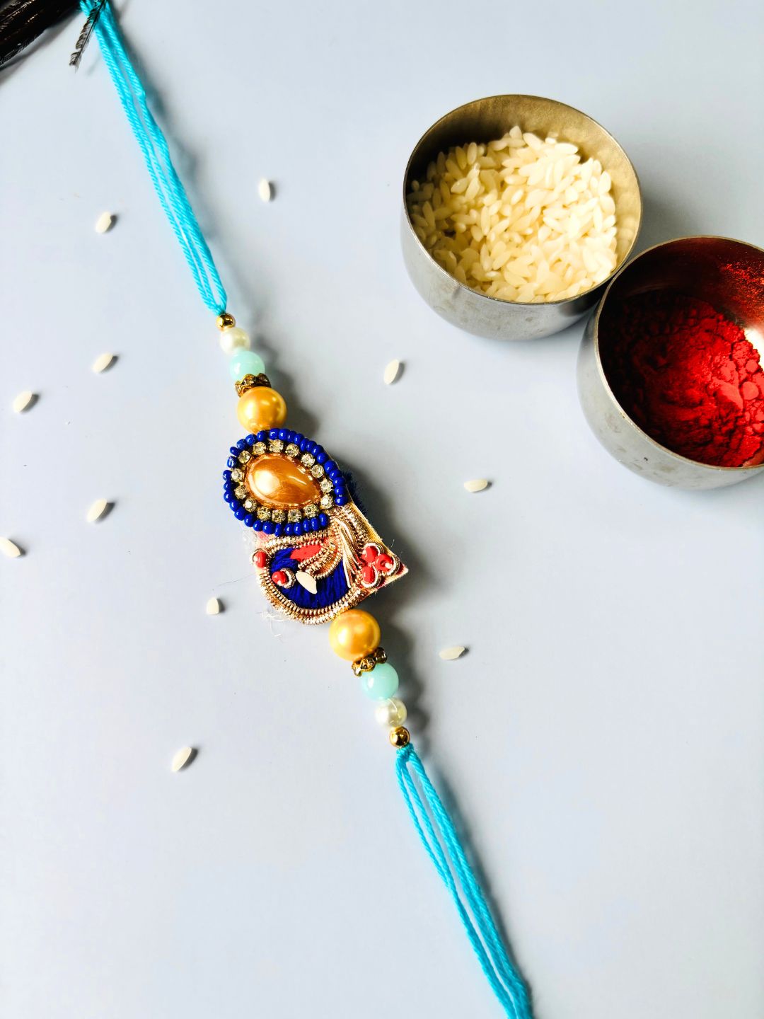 Blue Embellished Lumba Rakhi Set for Bhaiya Bhabhi with Roli Chawal