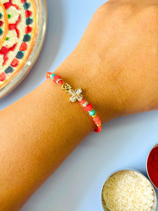 Om AD Stone Rakhi with Floral Accent with Roli Chawal for Brother