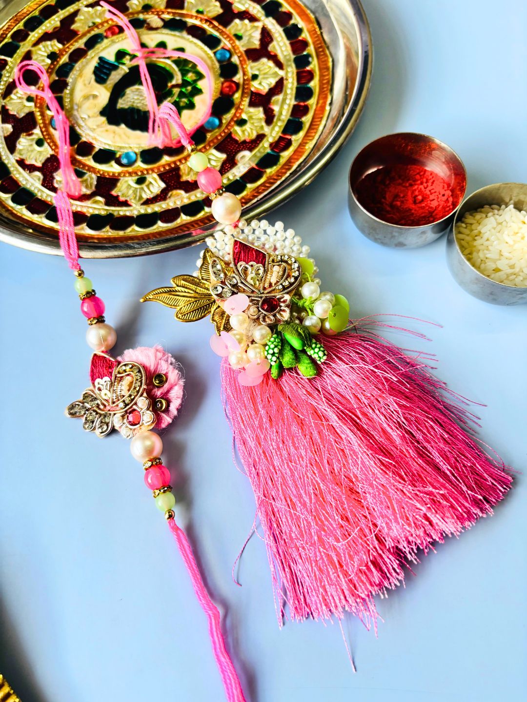 Pink Embellished Lumba Rakhi Set for Bhaiya Bhabhi with Roli Chawal