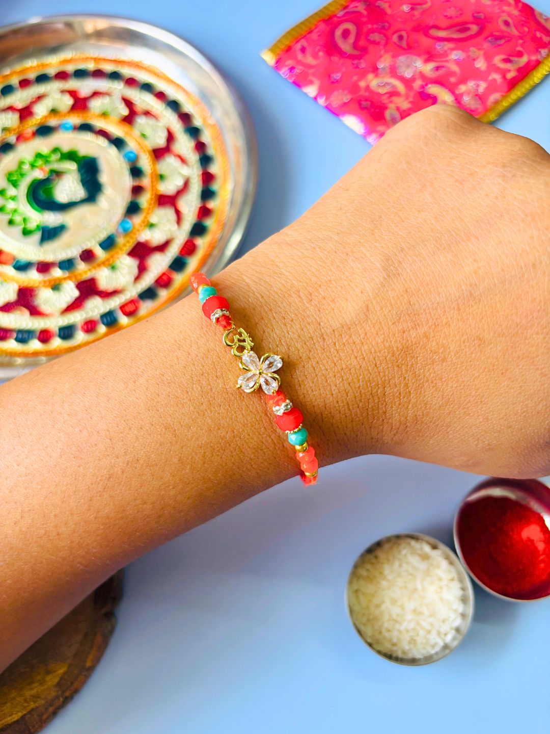 Om AD Stone Rakhi with Floral Accent with Roli Chawal for Brother