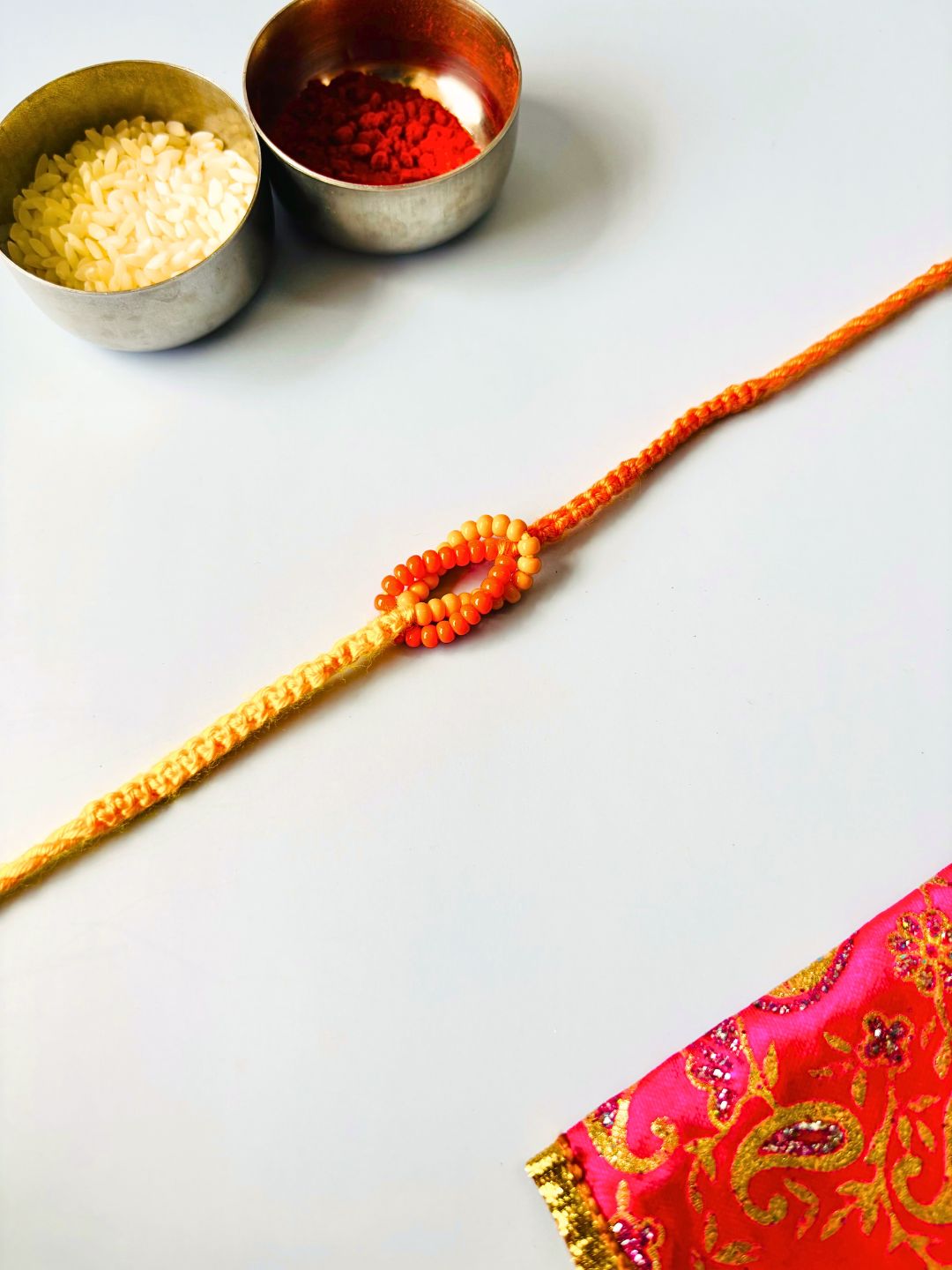 Orange Beaded Thread Rakhi with Roli Chawal