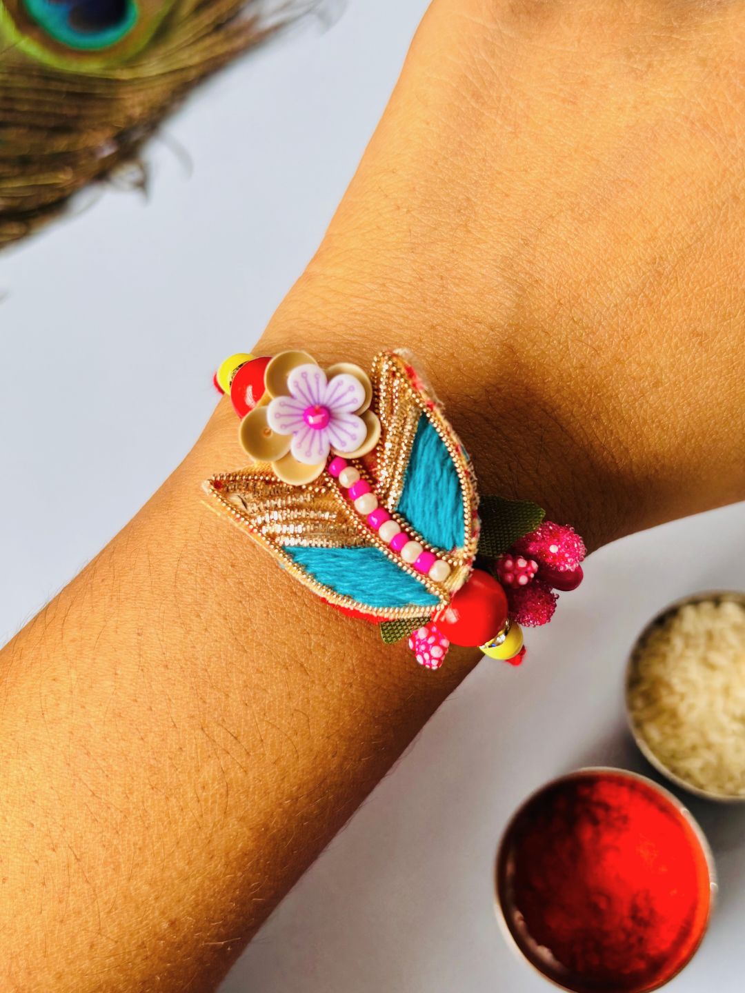 Cute Floral Rakhi with Roli Chawal for Brother (Pack of 2: Blue and Orange)
