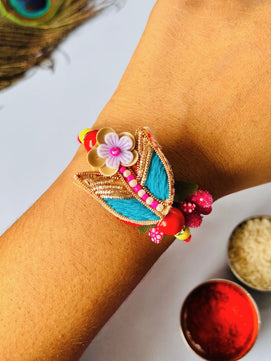 Cute Floral Rakhi with Roli Chawal for Brother (Pack of 2: Blue and Orange)